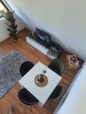 a living room with a table and chairs and a tv at Vikendica na Avali in Donja Ralja