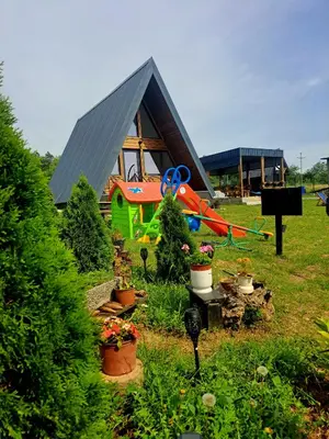 a small house with a garden in front of it at Vikendica na Avali in Donja Ralja
