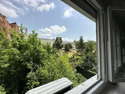 an open window with a view of a building at petrov apartman in Belgrade