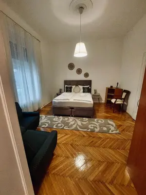 a bedroom with a bed and a couch at Sweet House Kalemegdan in Belgrade