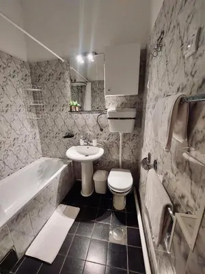 a bathroom with a sink and a toilet and a tub at Sweet House Kalemegdan in Belgrade