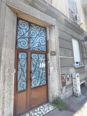 a large wooden door with a metal gate on a building at Sweet House Kalemegdan in Belgrade