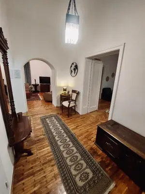 a living room with a rug on a wooden floor at Sweet House Kalemegdan in Belgrade