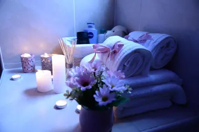 a room with towels and candles and a vase of flowers at Leona apartment in Zemun
