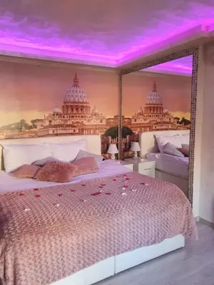 a bedroom with a bed with a purple ceiling at Leona apartment in Zemun