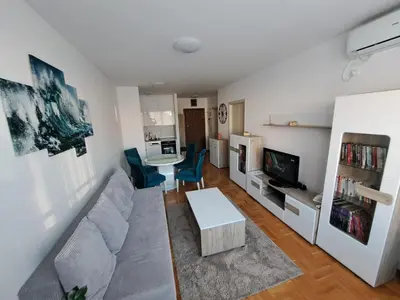 a living room with a couch and a table at Plavi Paun Apartman in Belgrade