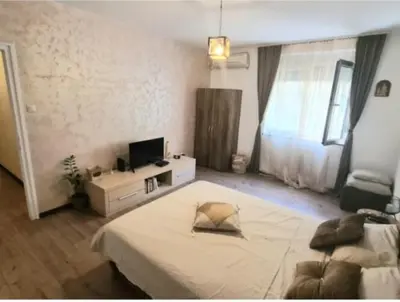 a bedroom with a large bed and a television at Magistar in Zemun
