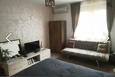 a living room with a bed and a couch at Magistar in Zemun