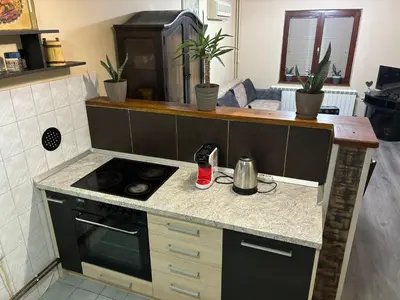 a kitchen with a stove and a counter top at Icy Apartment in Belgrade