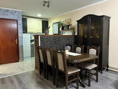 a kitchen and dining room with a table and chairs at Icy Apartment in Belgrade