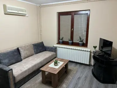 a living room with a couch and a table at Icy Apartment in Belgrade
