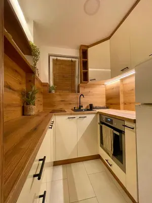 a kitchen with white cabinets and a sink at Osho in Smederevo