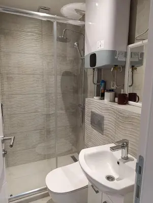 a bathroom with a shower and a toilet and a sink at Apartman Kokan in Obrenovac