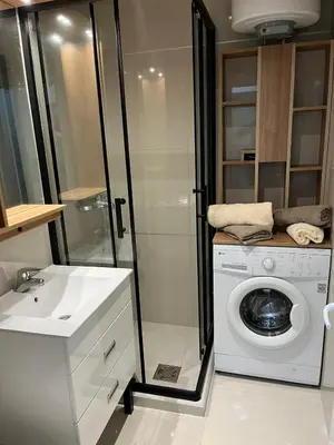 a bathroom with a washing machine and a sink at Apartman Silver Bg in Kneževac