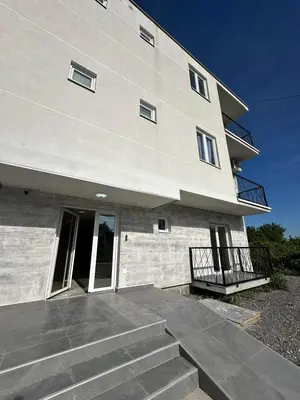 a large building with stairs in front of it at Apartman Andjela in Surčin