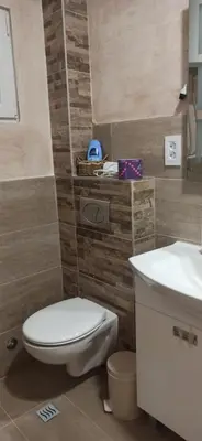 a bathroom with a toilet and a sink at Apartman Andjela in Surčin