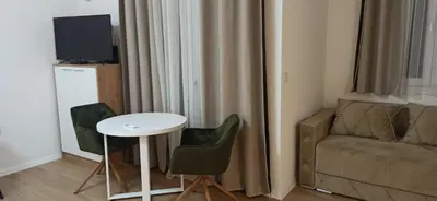 a living room with a couch and a table and a chair at Apartman Andjela in Surčin