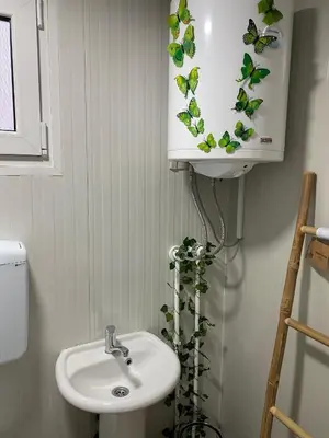 a bathroom with a sink and a plant at Danube Oasis Stevantown 2 in Stari Banovci