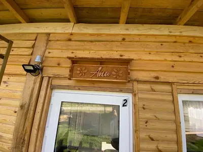a wooden house with a sign above a door at Danube Oasis Stevantown 2 in Stari Banovci