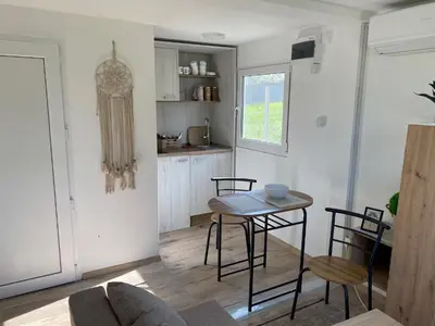 a kitchen with a table and chairs in a room at Danube Oasis Stevantown 2 in Stari Banovci
