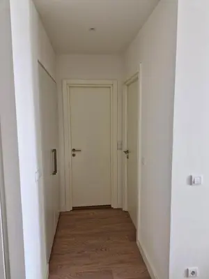 an empty hallway with white walls and a door at Belgrade Waterfront BW Sava Aqua in Sajmište