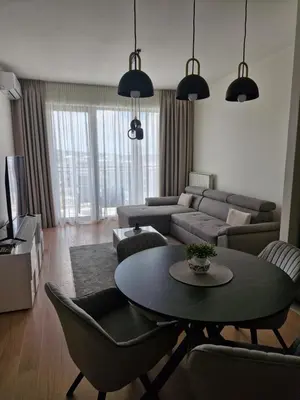 a living room with a couch and a table at Belgrade Waterfront BW Sava Aqua in Sajmište