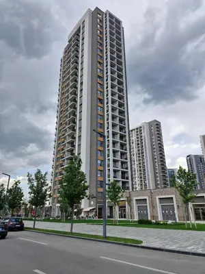 a tall building on the side of a city street at Belgrade Waterfront BW Sava Aqua in Sajmište