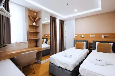 a hotel room with two beds and a desk at Belgrade Rooftop Experience, Modern Luxury & Views in Belgrade