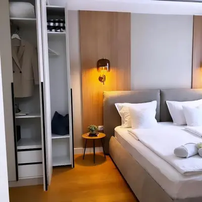a bedroom with a bed and a closet at Belgrade Rooftop Experience, Modern Luxury & Views in Belgrade