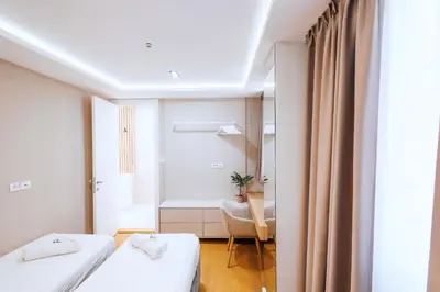 a hotel room with two beds and a desk at Belgrade Rooftop Experience, Modern Luxury & Views in Belgrade