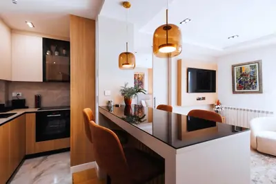 a kitchen and living room with a counter and chairs at Belgrade Rooftop Experience, Modern Luxury & Views in Belgrade