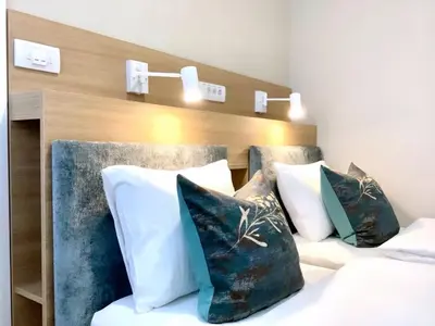 a bedroom with two beds with pillows and a headboard at Belgrade Rooftop Experience, Modern Luxury & Views in Belgrade