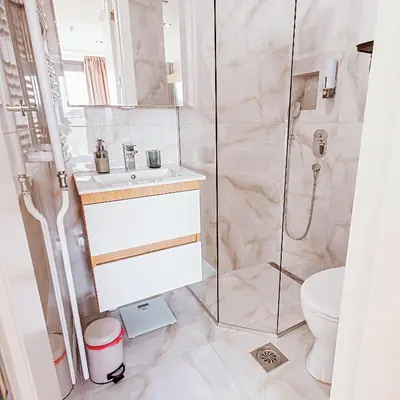 a bathroom with a shower and a toilet at Belgrade Rooftop Experience, Modern Luxury & Views in Belgrade