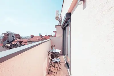 a balcony with a table and chairs on a building at Belgrade Rooftop Experience, Modern Luxury & Views in Belgrade