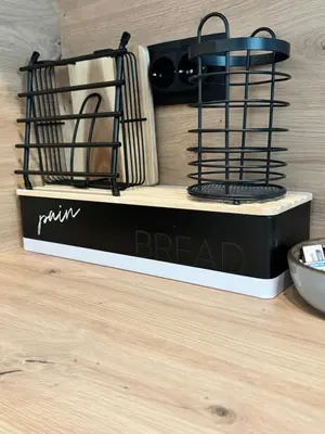 a black and white bread sign on a wooden floor at Fairy tale apartment 8 in Voždovac