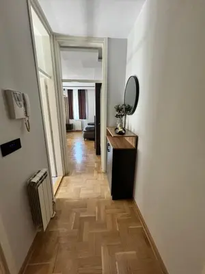 a hallway with a mirror on the wall and a table at Fairy tale apartment 8 in Voždovac