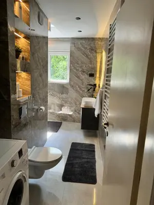 a bathroom with a toilet and a sink at Fairy tale apartment 8 in Voždovac