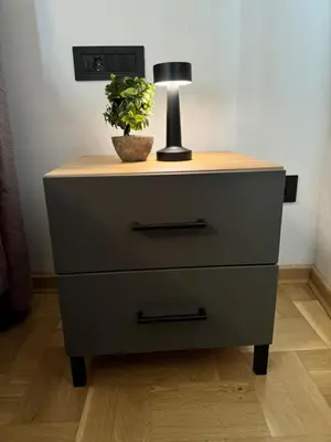 a dresser with a lamp and a plant on it at Fairy tale apartment 8 in Voždovac