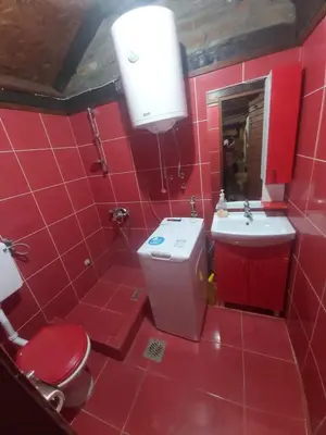 a red bathroom with a toilet and a sink at Etno selo Smederevo PEPE- Serbia in Landol