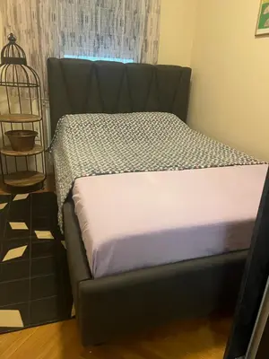 a bed sitting in a room with a couch at Sofia in Belgrade