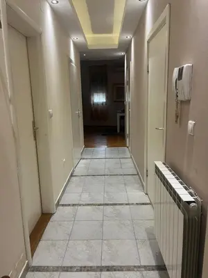 a hallway with a tile floor and a hallway with a phone at Sofia in Belgrade