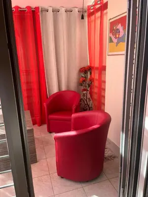 two red chairs in a room with red curtains at Sofia in Belgrade