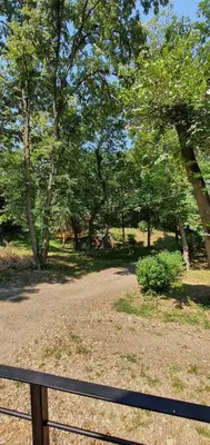 a park with a fence and trees in the background at Woodnest in Čortanovci