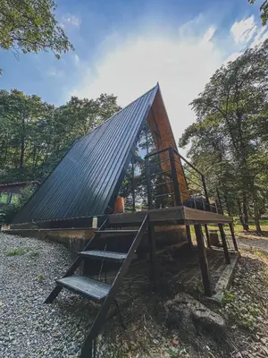 a tiny house with a roof and a staircase at Woodnest in Čortanovci