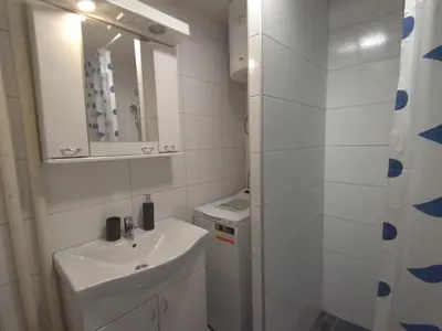 a white bathroom with a sink and a mirror at Lea Beo in Belgrade