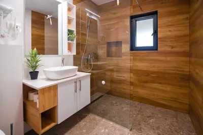 a bathroom with a sink and a glass shower at Uba Fruška gora in Velika Remeta