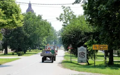 a truck driving down a road with a person in the back at Ćirino Sokače in Opovo