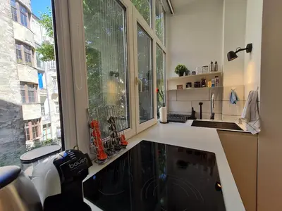 a kitchen with a sink and a large window at Jana - Cozy Apartment in the Old Town in Belgrade
