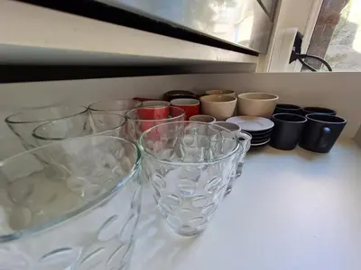a group of glasses sitting on top of a counter at Jana - Cozy Apartment in the Old Town in Belgrade