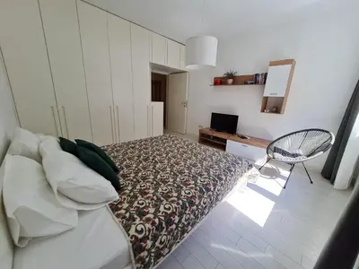 a bedroom with a bed and a desk and a chair at Jana - Cozy Apartment in the Old Town in Belgrade